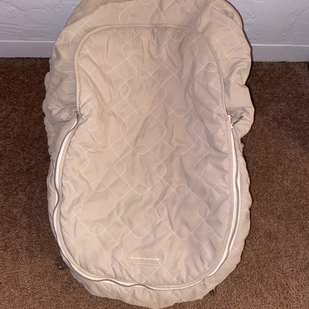 JJ Cole Car seat Cover beige in color. Gently used